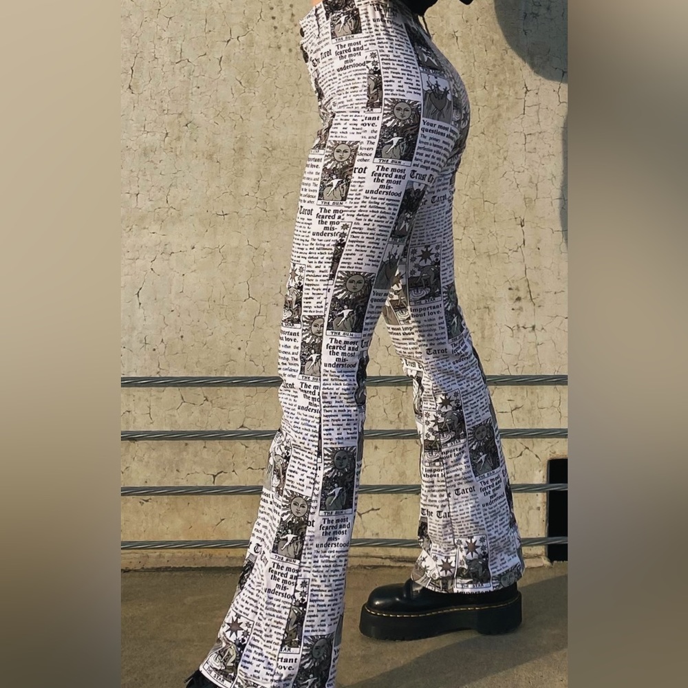 Newspaper printed pants with tarot card readings
